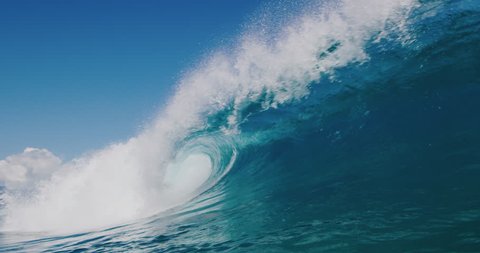 Powerful ocean wave breaking, deep blue wave barrel in warm tropical waters, blue planet