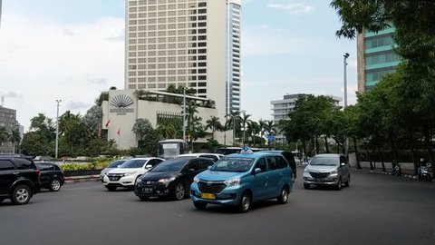 Jakarta, Indonesia - February 16, 2019: Traffic on Jalan Thamrin (Thamrin street) around Bundaran HI (Hotel Indonesia Roundabout)