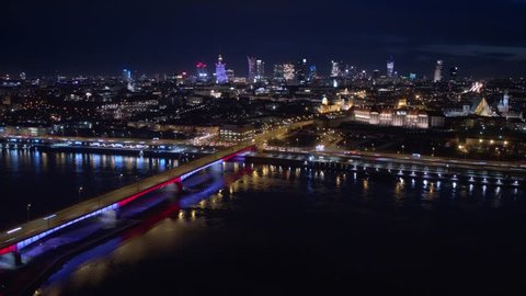 Night City Aerial Timelapse. City skyline background. Aerial view of Warsaw capital city of Poland.
From above, night city view with night sky. Night panorama of Warsaw cityscape.