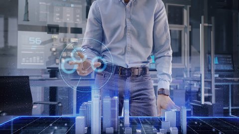Professional Architect works with Holographic Augmented Reality 3D City Model using gestures. Technologically Advanced Office use Augmented Virtual Modeling Software Application on Futuristic Display.