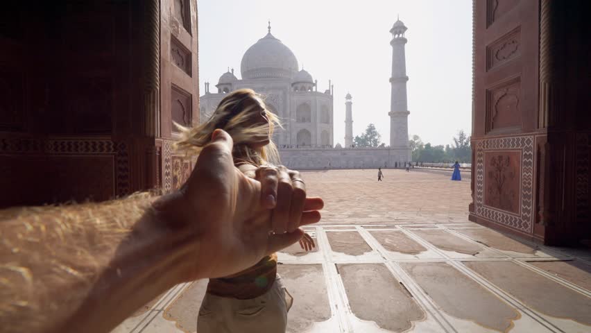 Follow me to the Taj Mahal, India. Female tourist leading boyfriend to there magnificent famous Mausoleum in Agra. People travel concept .leading the way | Shutterstock HD Video #1027054340