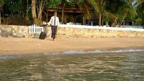 happy businessman in a suit and dark glasses is splashing in the sea at luxury resorts. concept of long-awaited vacation, freelancing. - Powered by Shutterstock - Get 15% off with code: PIKWIZARD15
