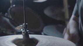 Close up of a Hi-Hat cymbal while a drummer plays.