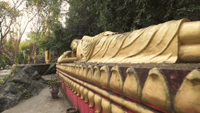 Slow-motion video of a gold-colored Sleeping Buddha statue on the Phou Si Mountain, Luang Prabang, Laos. Mount Phu Si, is a 100 m high hill in the centre of the old town of Luang Prabang in Laos