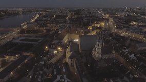 Aerial view of the royal palace in the old town at night Warsaw. Night illumination of the facade is beautifully decorated with ancient buildings. Drone shot 4k. Video format RAW.