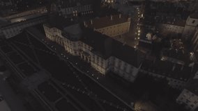 4K. Aerial view of the castle square in the old town of Warsaw at night. Span over the square and the royal castle, view of the ancient architecture in the evening. Drone shot. Video format RAW.