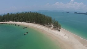 Aerial video of tropical beach on the Kam island, Ranong, Thailand. Beautiful aerial view of island with sand beach and boat.