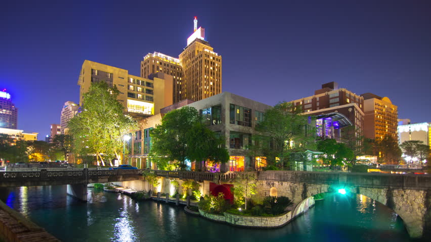 Downtown San Antonio River Night Generic Cityscape Timelapse with Passing Colorful Attraction Boats and Tourists Visiting the Popular City Center Riverwalk District