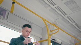 Adult Man is Putting Earphones and Listening to the Music from Smartphone with In-ear Headphones while Travelling by Train. Two 4k Slow Motion video shots in one.