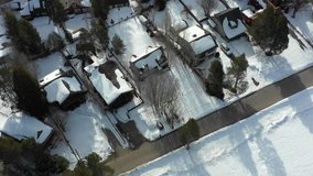 Aerial flyover neighborhood homes covered in snow 4k
