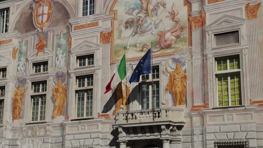 Genova, Liguria, Italy. 04/05/2019. Palazzo San Giorgio and the elevated road. The fresco paintings on the façade of Palazzo San Giorgio are the background to the traffic on the elevated road.