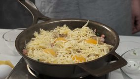 Eggs, bacon and cheese mozzarella cooking on iron pan background. Food cooking concept.