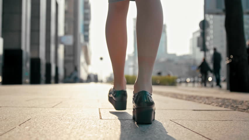 Ladylike candid with nice legs walking in the street