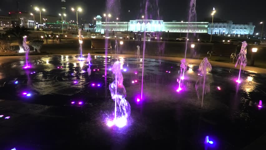 Colorful water fountain at Souq Waqif Park at Doha Corniche illuminated at night. Famous tourist attraction in Doha. Qatar, Middle East, Arabian Peninsula in Persian Gulf.