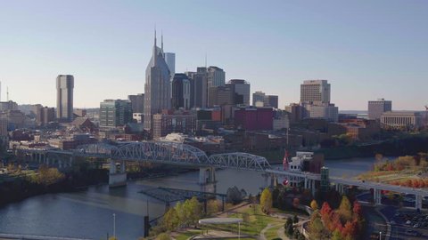 Nashville city, aerial pan with John Seigenthaler Pedestrian Bridge and city skyline on beautiful morning sunrise