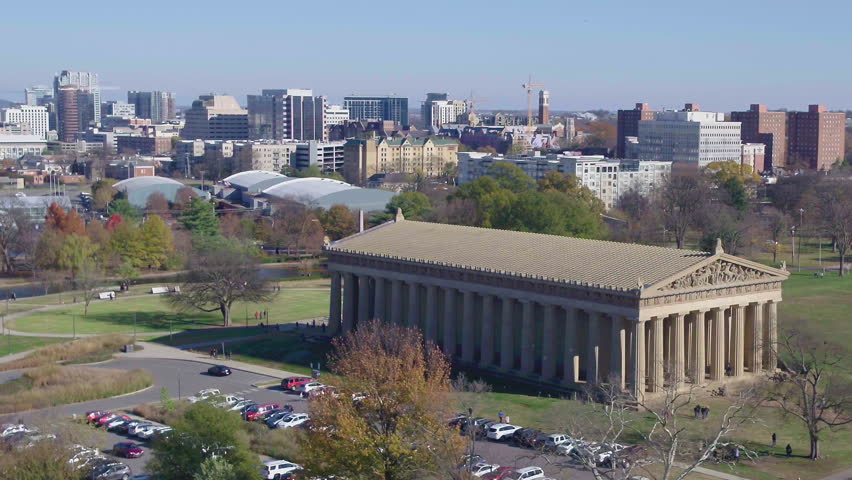 Slow aerial pan of Centennial Park, with Nashville city in the distance on sunny day 4k