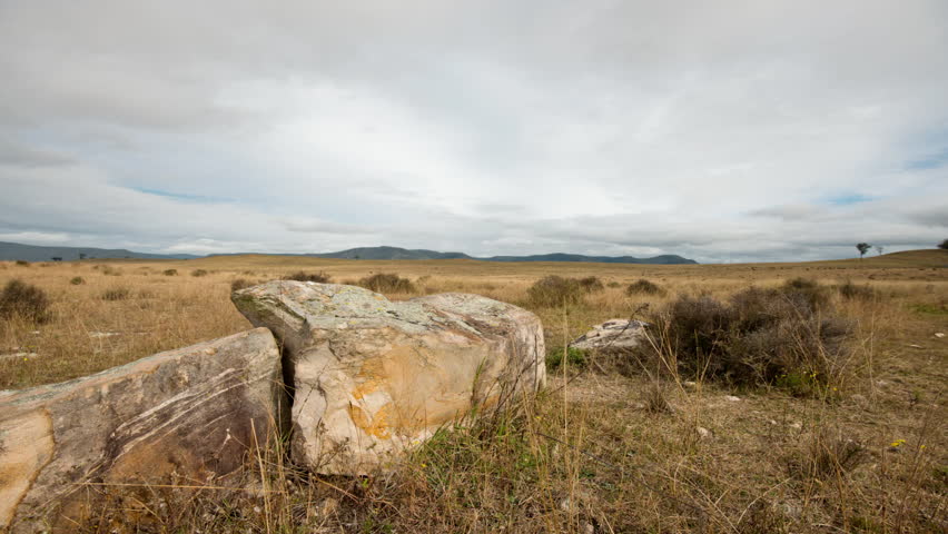 Cloudscape Time-lapse with large boulders in the foreground