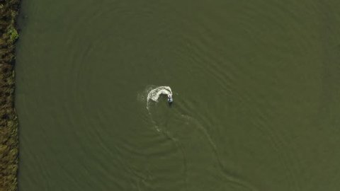 Overhead view of someone jet skiing and doing doughnuts in the Delta in Antioch Northern California