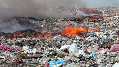 Burning garbage dump pollution, landfill near the city