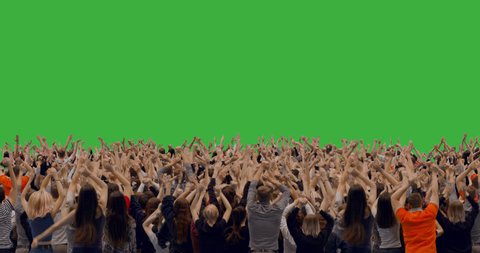 GREEN SCREEN CHROMA KEY Model released, back view of huge crowd jumping and cheering at a concert or a show. 4K UHD ProRes 4444