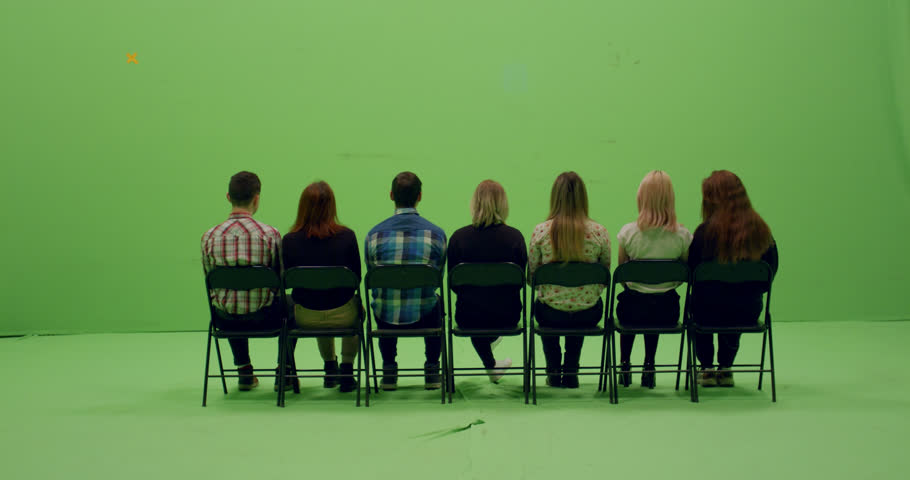 GREEN SCREEN CHROMA KEY Back view group of young people sitting on chairs. 4K UHD ProRes 4444