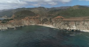Aerial Drone Stock Video of Bixby Bridge Highway with water and shore below in Big Sur Monterrey California