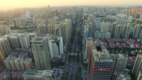 AERIAL shot of traffic moving on road and cityscape at sunset/Xi'an,China
