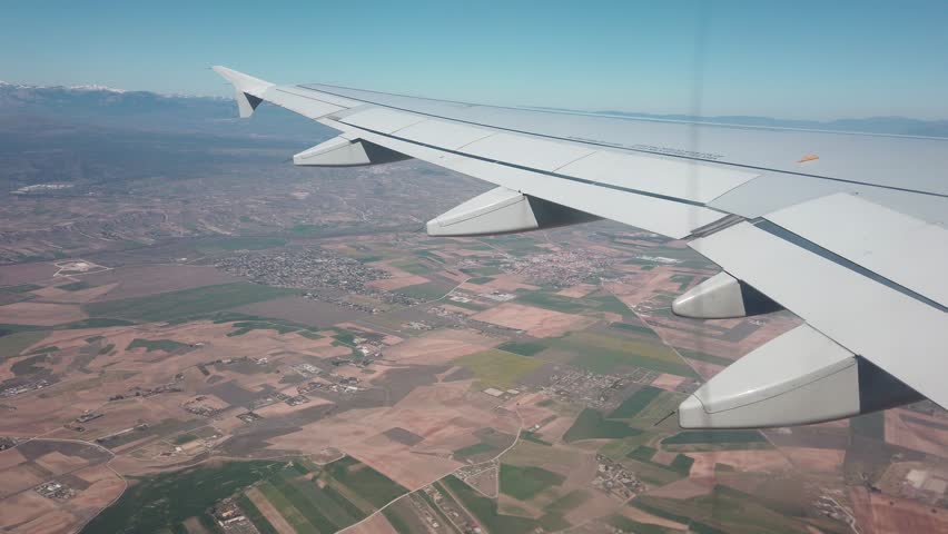 Airplane flying, view from passenger seat through window | Shutterstock HD Video #1027146815