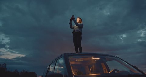 Hipster girl taking photos or sending text message on telephone during road trip, Slow Motion, Shot on Cine Camera 4K, Cinematic Shot