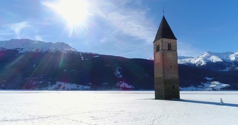An aerial view over Bell tower of Resia Lake, in Italy, South Tyrol in winter