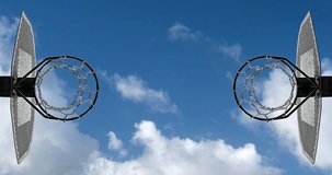 Metallic basketball hoop timelapse. Blue sky and white clouds at the background. Below view with copy space for text