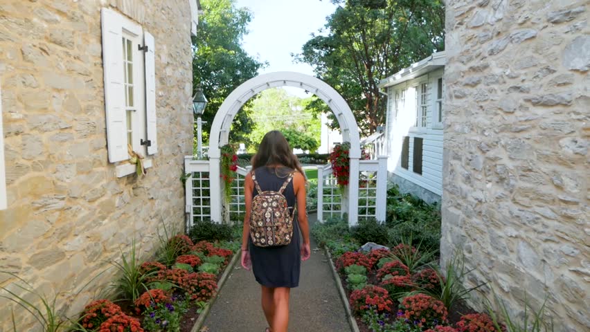 Follow Shot of a Young Woman Exploring a Cute Town.