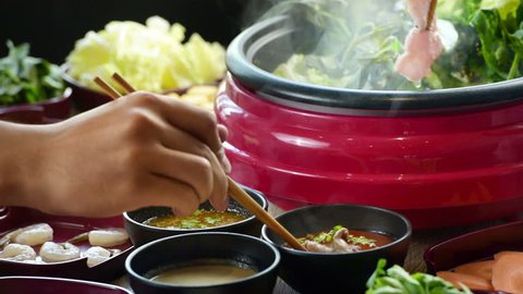 enjoy eating Shabu Shabu and Sukiyaki in hot pot at japanese 
restaurant.Japanese food are high quality food cooking in hot boil soup with vegetable beef raw meat or sea food hold with chopsticks