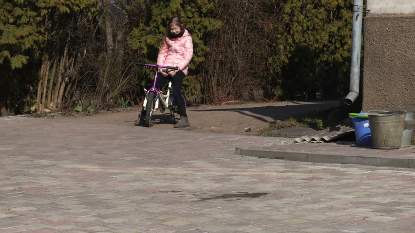 Girl practicing riding bicycle