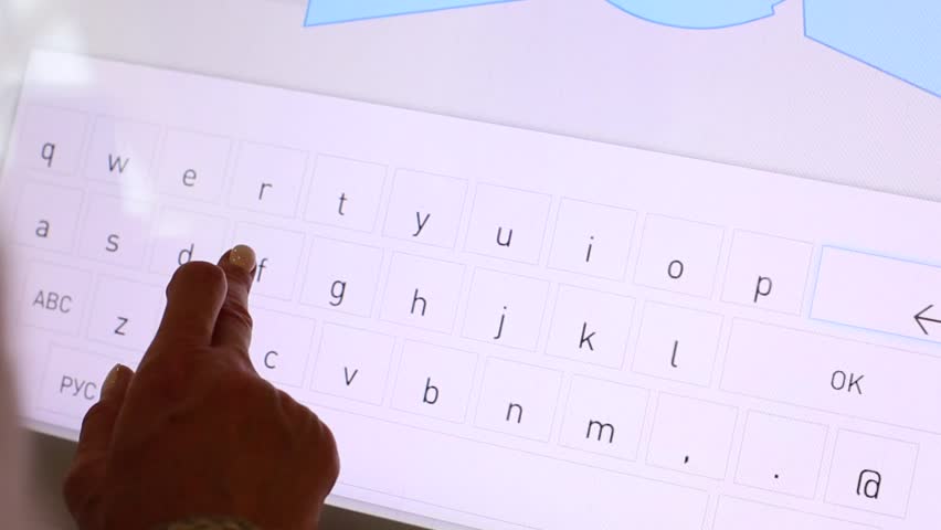 The woman uses an interactive panel as a shopping center guide. Paves the way to the desired store