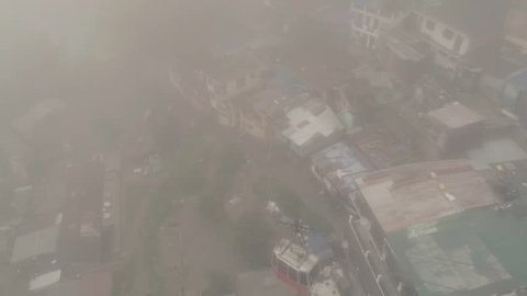 Morning foggy shot of cable lift(Gondola lift in mountains).Aerial/drone shot of gondola lift over mountain city.(India, nanital).Cable transport over city in nanital/uttarakhand.