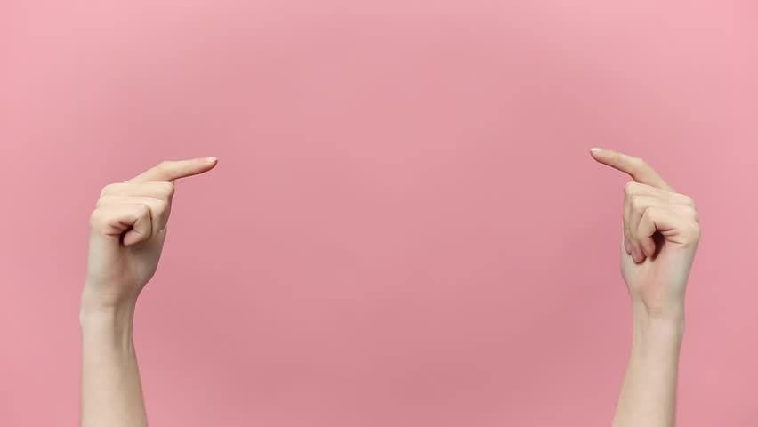 Woman hands pointing on copyspace isolated over pastel pink background in studio. Copy space for advertisement. With place for text or image, promotional content. Advertising area, workspace mock up.