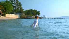 happy businessman in a suit and dark glasses is splashing in the sea at luxury resorts. concept of long-awaited vacation, freelancing. - Powered by Shutterstock - Get 15% off with code: PIKWIZARD15