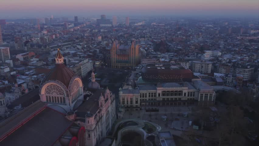 Video shows the beautiful train station in Antwerp with sunrise background. The sky orange sky turn the station into golden color. The station is the most beautiful station in world.