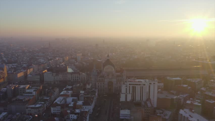 Video shows the beautiful train station in Antwerp with sunrise background. The sky orange sky turn the station into golden color. The station is the most beautiful station in world.
