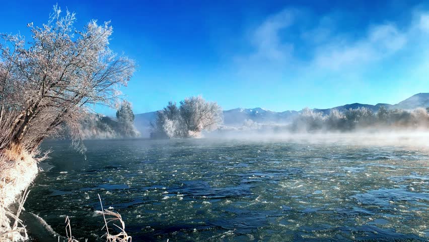 Beautiful river in winter rolling through the Mountains of Montana