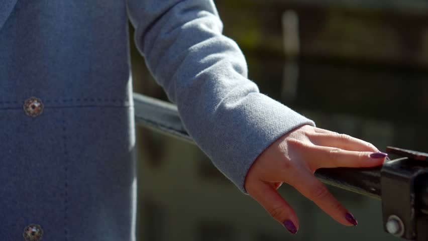 Outdoor shot of a woman taking a city walk by the river.
