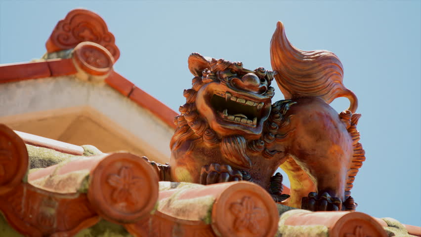 Shisa, a lion shaped statues placed as talisman against evil at entrances and on roofs.