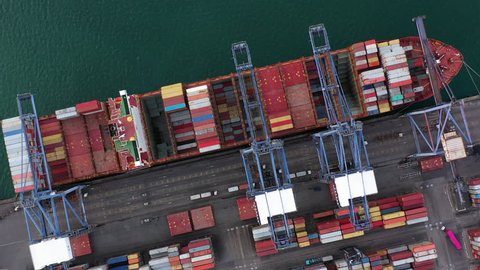 4K, Container ship loading and unloading in deep sea port, Aerial view of business logistic import and export freight transportation by container ship, Container loading cargo freight ship.