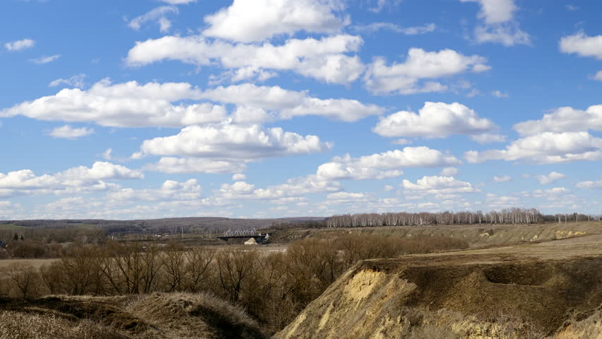 Landscape, distance cliffs railway bridge. Shadow covers the ground.