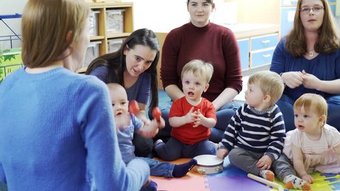 Mothers And Babies Playing Instruments And Singing At Music Group 