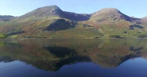 Lake District National Park, Cumbria, England, United Kingdom, Europe - CIRCA 2018: The Lake Buttermere pines and peaks of High Crags