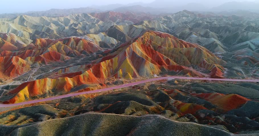 Drone flight over most colorful mountains on earth, the Rainbow mountains of Zhangye. Shown is the most vibrant, multicolored part of this amazing landscape located in Gansu, China.  Royalty-Free Stock Footage #1027223300