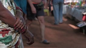 Woman standing wearing sari, a traditional Indian garment and bangles as they crowd passes her at a make shift bazaar on the beaches of Goa, a popular travel destination in India - Powered by Shutterstock - Get 15% off with code: PIKWIZARD15