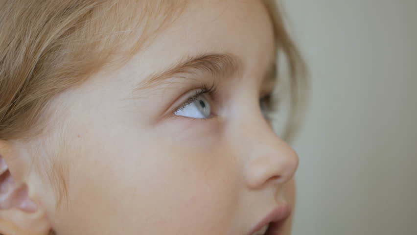 Portrait little young girl with blue eyes looking up. Closeup | Shutterstock HD Video #1027225571